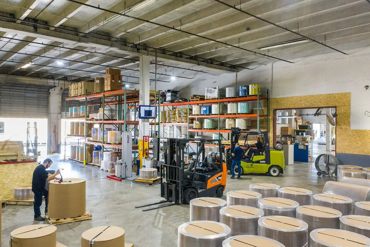 Multiple forklifts operating in a warehouse during three-shift fleet duty